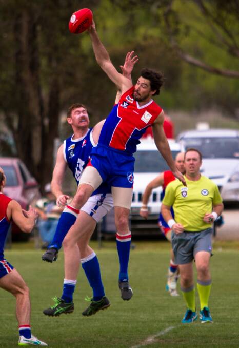 TAP: St Arnaud ruckman Luke Wells wins this ruck duel against Donald's Nathan Dunstan on Saturday. The Saints are through to the grand final. Pictures: JASON SMITH