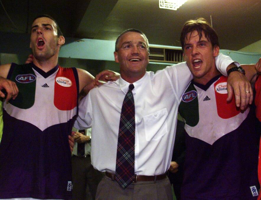 DOCKER VICTORY: Damian Drum (middle) celebrates a Fremantle win over Port Adelaide. Drum coached the Dockers for 53 games starting in 1999. 