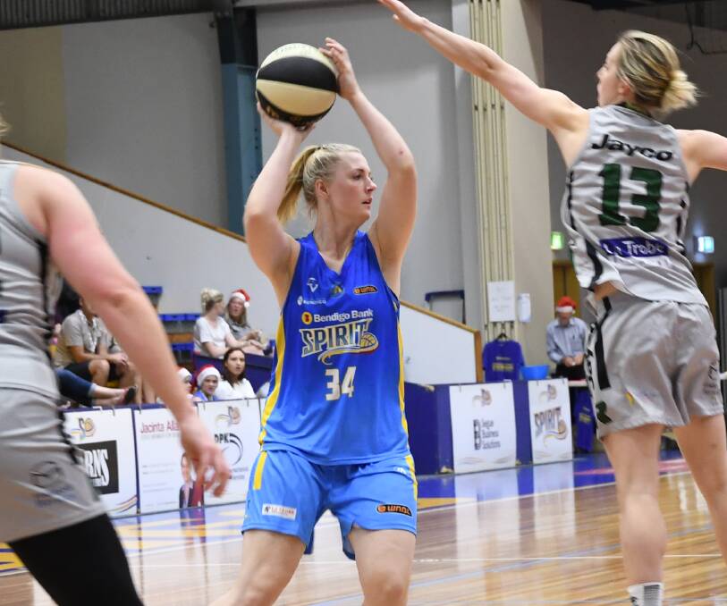 VICTORIOUS: Bendigo Spirit's Maddi Wild, who is pressured by Sam Richards, looks for a team-mate to pass off to against Dandenong.