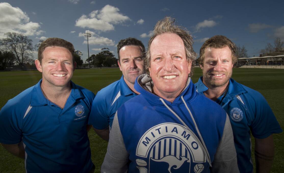 FOOTY FAMILY: Mitiamo's last premiership coach Bill Grant (front) with sons Matt, Andy and Tom. Picture: DARREN HOWE