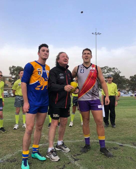 SPECIAL GUEST: Kevin Sheedy tosses the coin before Friday night's opening match between Bears Lagoon-Serpentine and Harcourt at Atkins Street.