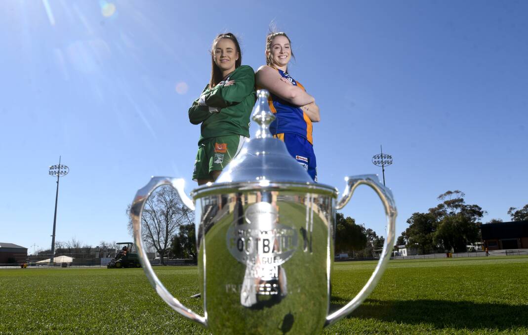 EYES ON THE PRIZE: Kangaroo Flat's Molly Metcalf and Golden Square's Carly McRae with the CVFLW premiership cup. Picture: NONI HYETT