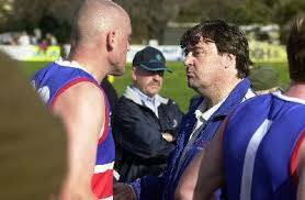 COACHING COUP: Mick McGuane, pictured talking to defender Eddie Barake, elevated Gisborne from just three wins in 2001 to 17-1 premiers in 2002.
