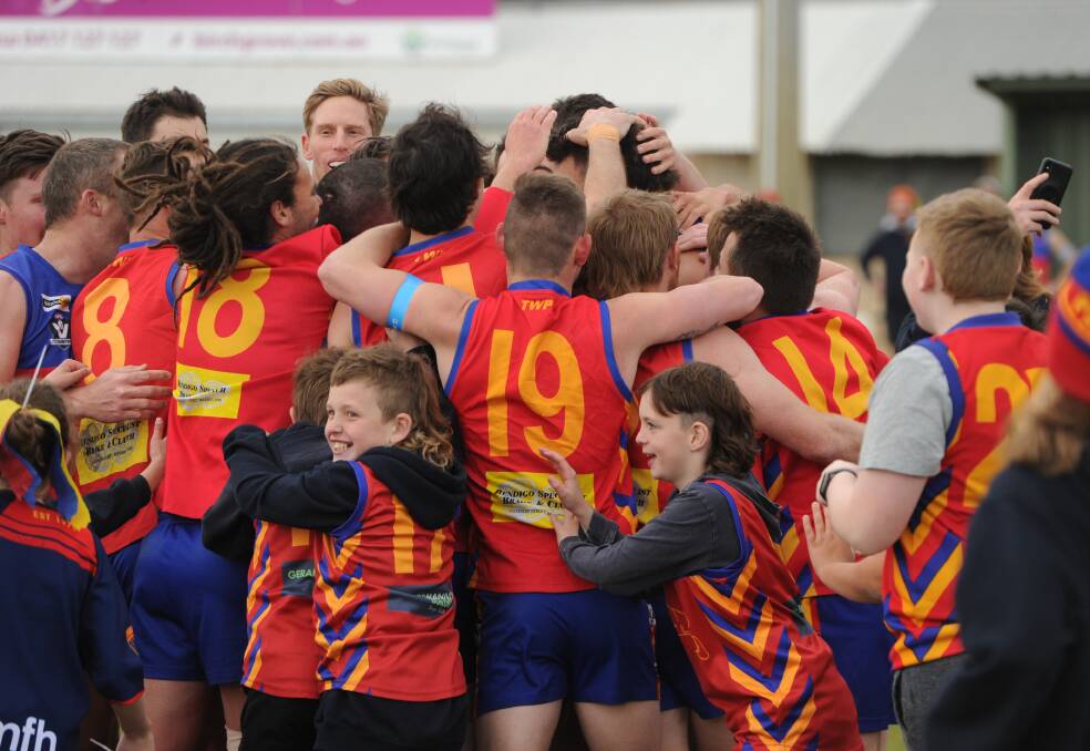 GET AROUND HIM: Marong players and young fans swarm around Brandyn Grenfell after he kicked his 100th goal for the season on Saturday. Grenfell finished with 15 goals against Newbridge. Pictures: ANTHONY PINDA