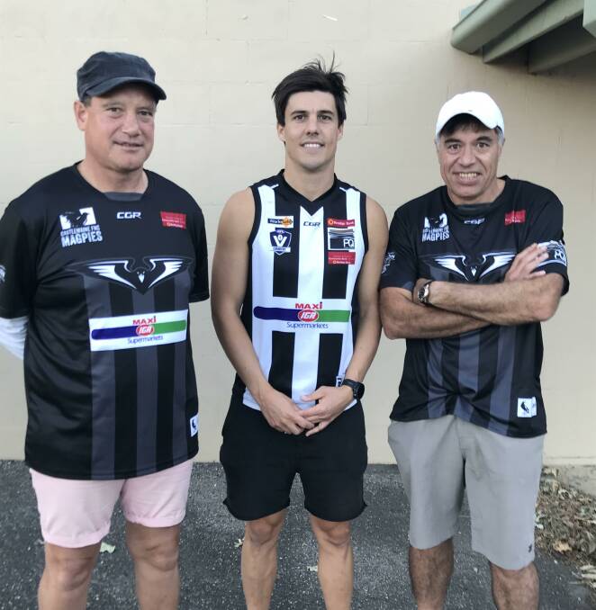STAR SIGNING: Castlemaine recruit Angus Monfries flanked by co-coaches Shawn and Derrick Filo at Camp Reserve on Friday night. Picture: LUKE WEST