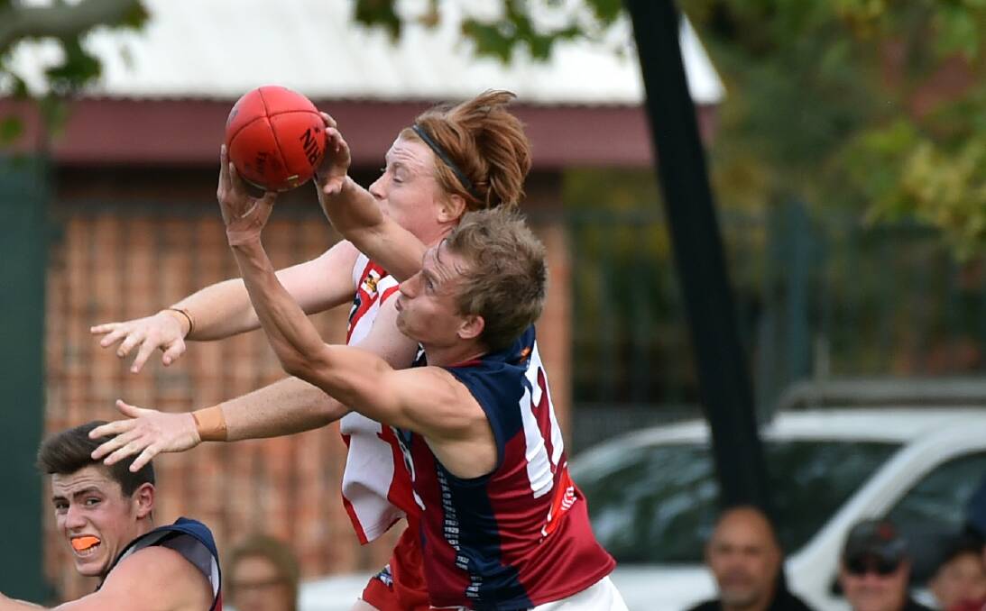 CONTEST: Sandhurst's Codie Price marks in this contest against South Bendigo's Will Keck at the QEO on Saturday. Picture: GLENN DANIELS