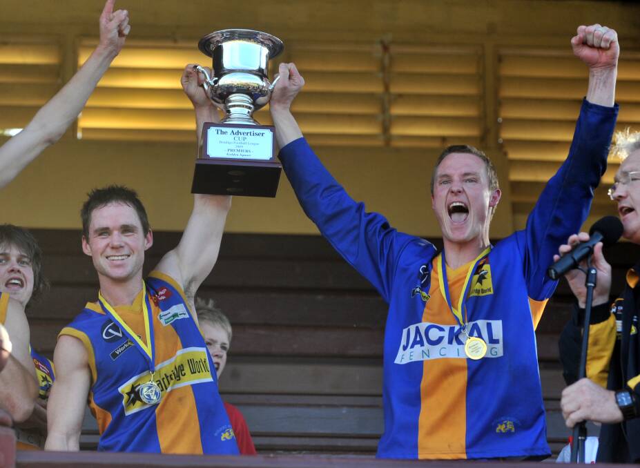 SILVERWARE: Golden Square captain Christian Carter and coach Mark Adamson hold aloft the 2009 BFNL Bendigo Advertiser premiership cup.