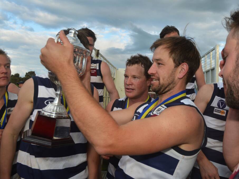 HOW SWEET IT IS: Lockington-Bamawm United's John Halloran with the 2013 HDFL premiership cup after the Cats beat Huntly by 58 points.