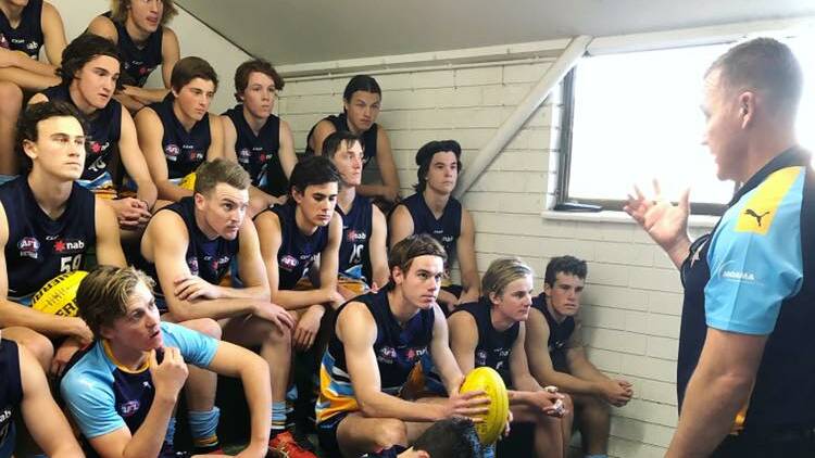 READY TO RUMBLE: Bendigo Pioneers players listen to coach Rick Coburn's pre-game address at Echuca on Saturday. The Pioneers were beaten by Sandringham by four points after the Dragons kicked four of the last five goals of the match to overhaul a 19-point deficit in their NAB League clash. Picture: PIONEERS FACEBOOK PAGE