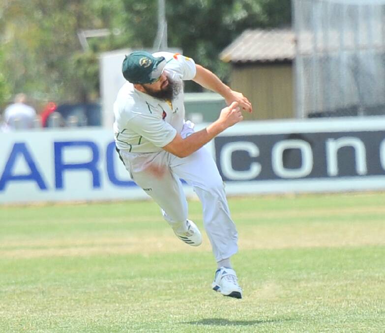 SUPERB GAME: Kangaroo Flat captain Brent Hamblin throws himself in the field during Saturday's BDCA win over Golden Square in which he took six wickets to go with his 50 last week. Pictures: LUKE WEST