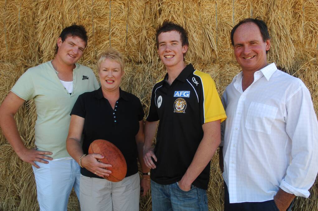 NEW TIGER: Andrew Collins with brother Alex, mum Sue and dad David on draft day in 2006 after he was selected by Richmond with pick 73.