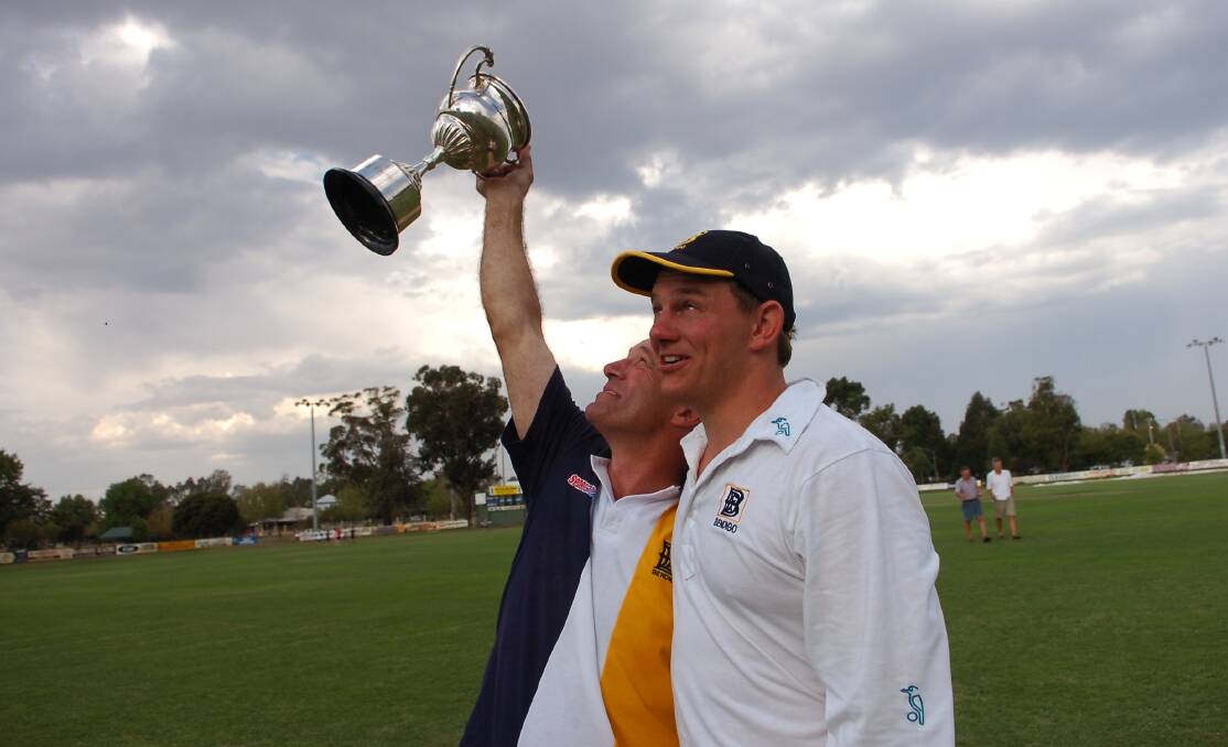 THIS IS FOR YOU, MATE: Coach Wayne Walsh with captain Heath Behrens salutes the late John Turner with the Melbourne Country Week premiership cup of 2007.