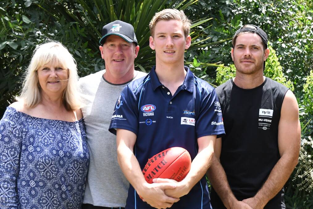EXCITING TIMES: Port Adelaide draftee Kane Farrell with parents Sue and Stephen and brother Brodie on Saturday. Picture: LUKE WEST