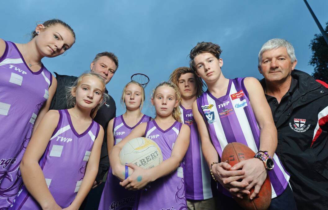 PURPLE TRIBUTE: Tayla, Lily, Grace and Matlida Edsall-French with Mark Segafredo, Dylan McCutcheon, Jackson Conforti and Andrew Conforti. Picture: DARREN HOWE