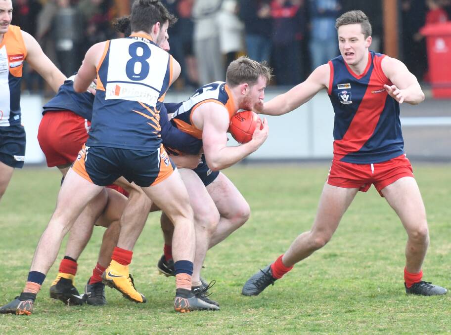 TENACIOUS: Maiden Gully YCW's Dylan Morris with a contested possession against Calivil United on Saturday. The Eagles have beaten the Demons by tight margins of four and three points this year. Picture: ANTHONY PINDA