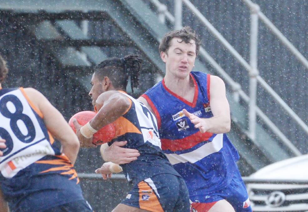 DRESS REHEARSAL: Pyramid Hill's Adrian Holland puts the pressure on Maiden Gully YCW's Natnael McLaren on Saturday. The two teams are likely to meet again in the qualifying final later this month. Picture: DARREN HOWE