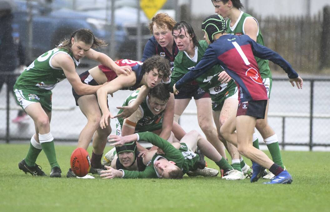 CONTESTED BALL: Conditions weren't pretty for Saturday's BFNL under-18 grand final between Kangaroo Flat and Sandhurst at the QEO.