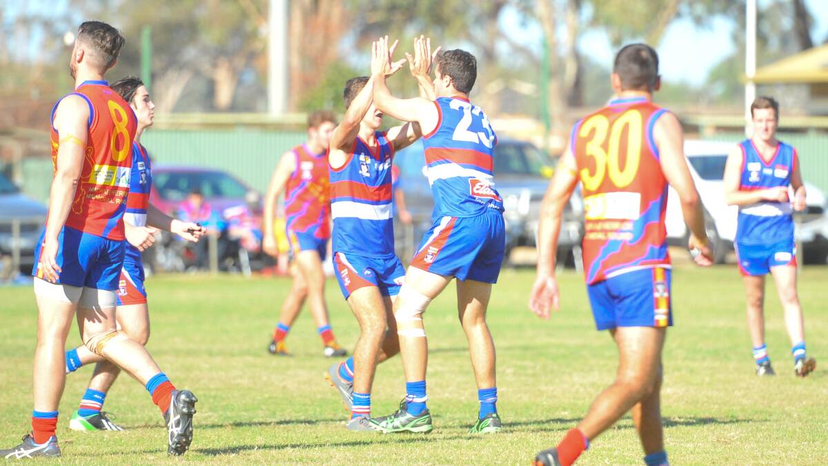 UP AND ABOUT: Steven Gunther and Nathan Fitzpatrick (No.23) celebrte a Pyramid Hill goal on Saturday. Picture: ADAM BOURKE
