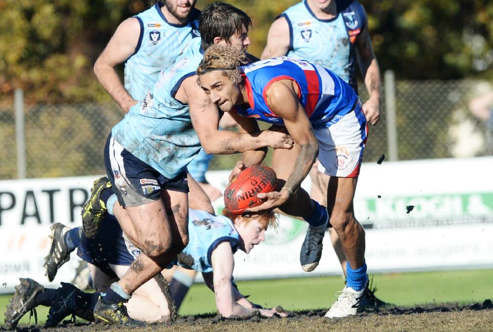 CONTESTED BALL: Eaglehawk's Brodie Collins lays a tackle on Gisborne's Andre Headberry during Sunday's clash at Canterbury Park. Picture: DARREN HOWE