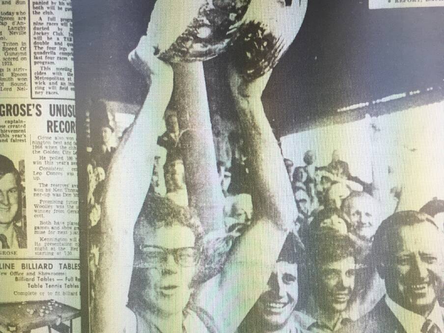 TOP DOGS: Golden Square coach Tony Southcombe holds aloft the premiership cup at the QEO after the 1975 grand final win over Sandhurst by 11 points.