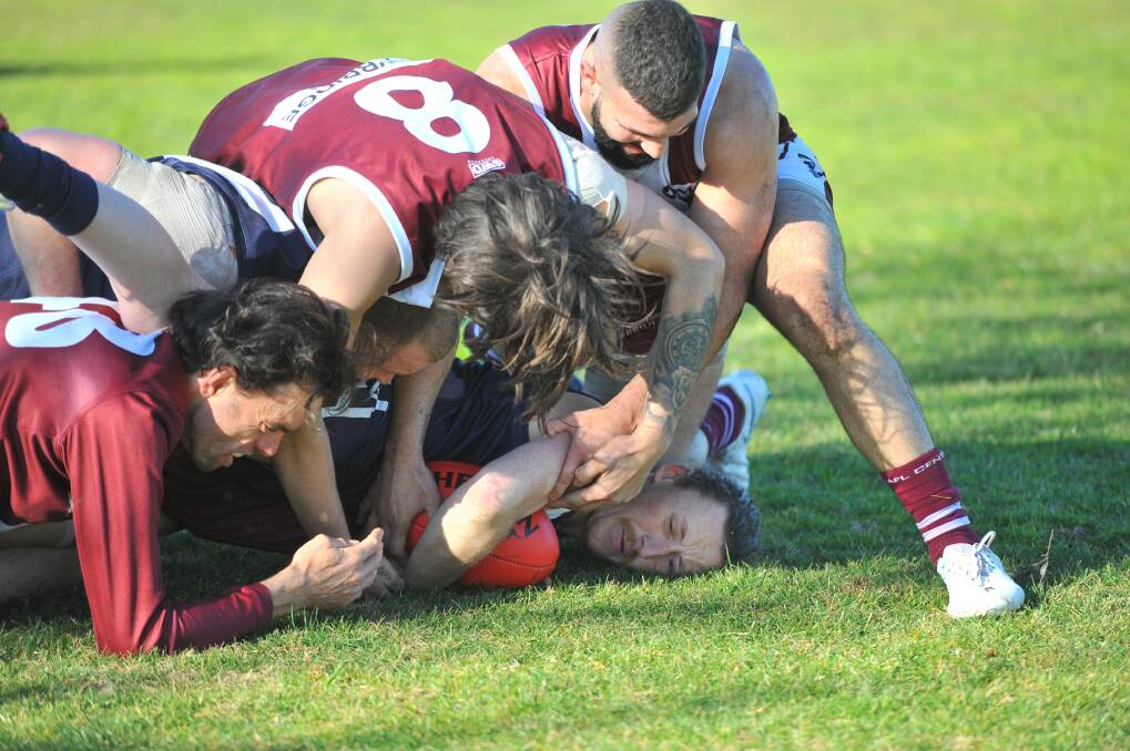 STACKS ON: Inglewood's Jarrod Starr finds himself at the bottom of a pack surrounded by Newbridge players during Saturday's LVFNL clash. The Maroons comfortably won by 97 points at Inglewood. Picture: ADAM BOURKE