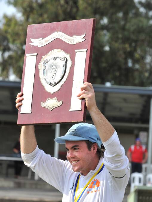 LEADER: Strathdale-Maristians' Linton Jacobs holds aloft the BDCA shield after the 2010-11 grand final - one of his five flags for the decade.