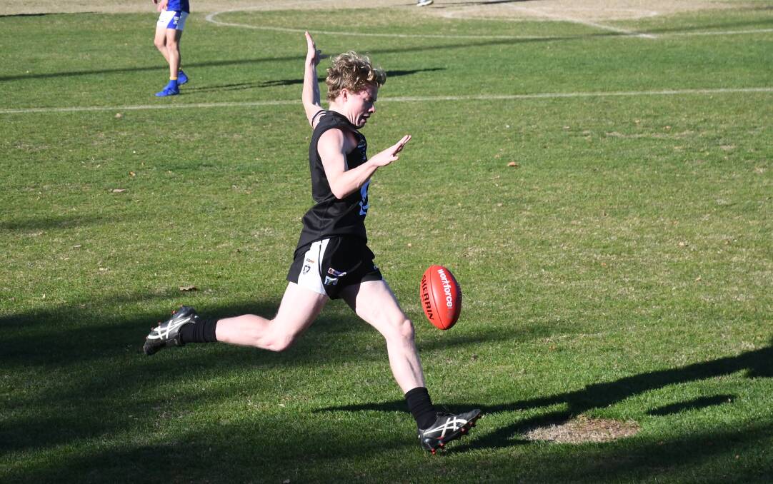 YOUNG TALENT: Castlemaine's Jack Chester kicks the Magpies forward during the first quarter on Saturday. The Magpies still haven't beat Golden Square since 2005.