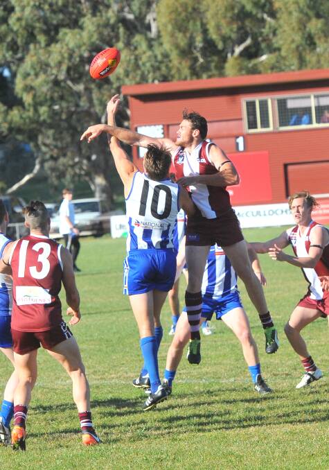 BIG MEN BATTLE: Mitiamo ruckman Michael I'Anson and Newbridge's Tyler Romeril contest a duel on the wing in the first quarter on Saturday. Picture: LUKE WEST