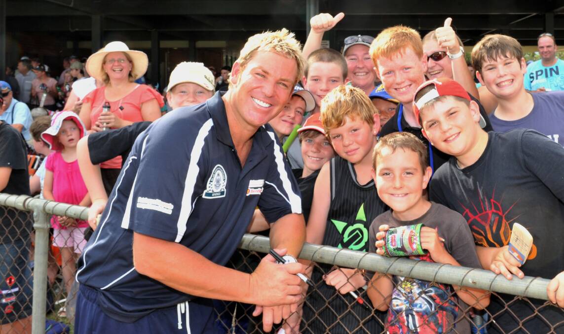 STAR ATTRACTION: Shane Warne with fans at the John Forbes Tribute Match at Kangaroo Flat's Dower Park in February of 2011.