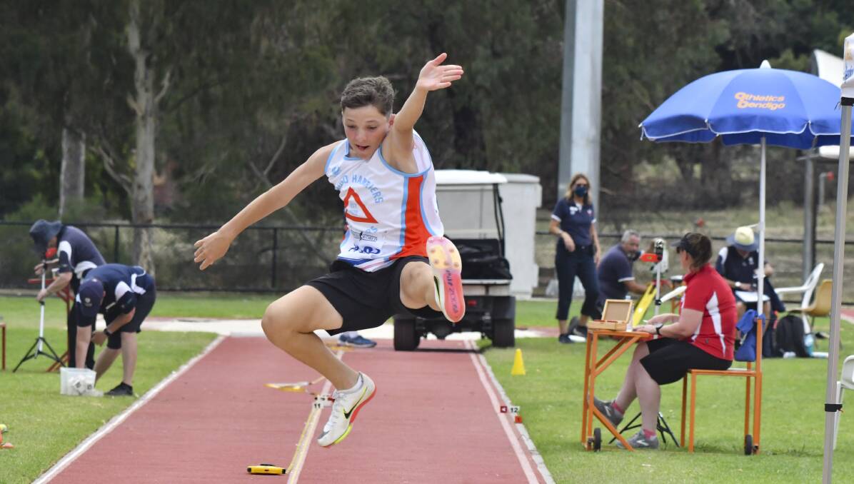 LEAP: Bendigo Harriers' Reeve Evans competes in Sunday's under-16 boys long jump final. Pictures: NONI HYETT