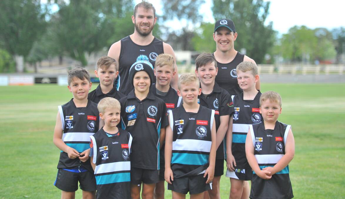 BACK HOME: Stewart Crameri (back left) with Maryborough coach Ben Lavars and a group of the club's junior players. Picture: LUKE WEST