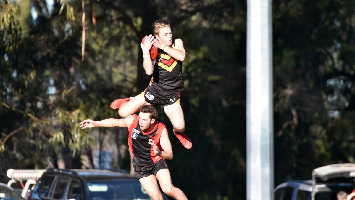 HIGH-FLYER: Leitchville-Gunbower young gun Logan Prout soars over the top of White Hills' Jed Lamb to take a scramer on Saturday. Picture: GLENN DANIELS