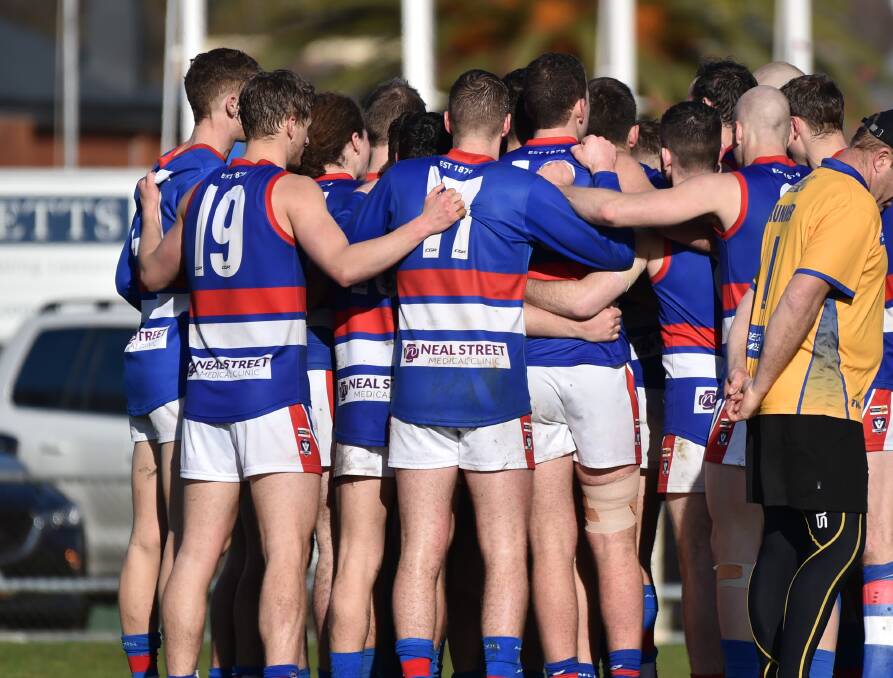 TIGHT GROUP: Gisborne players huddle up during their crucial three-point win over Golden Square a fortnight ago. The Bulldogs will play their first final since 2014 on Sunday against Sandhurst in the elimination final.
