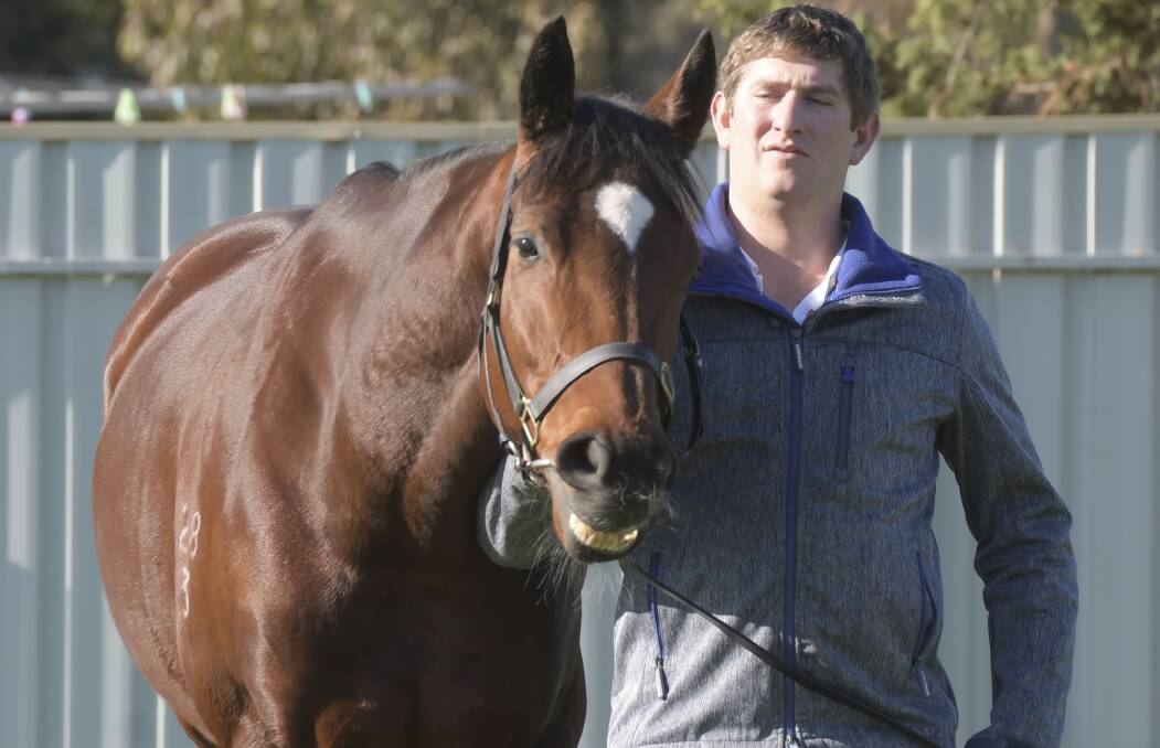 READY AND RAING: Bendigo trainer Kym Hann with She's Beneficial. Picture: NONI HYETT