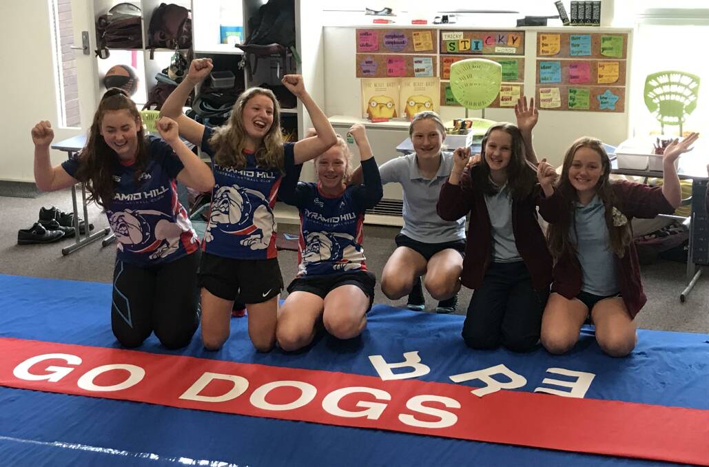EXCITEMENT: Students from Pyramid Hill College make one of the banners for grand final day on Saturday. Pyramid Hill has five teams competing for premierships.