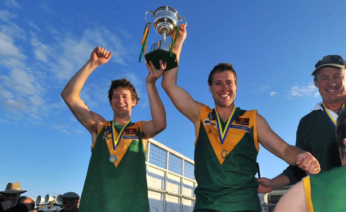 Brent Millar (right) holds aloft the 2008 premiership cup.