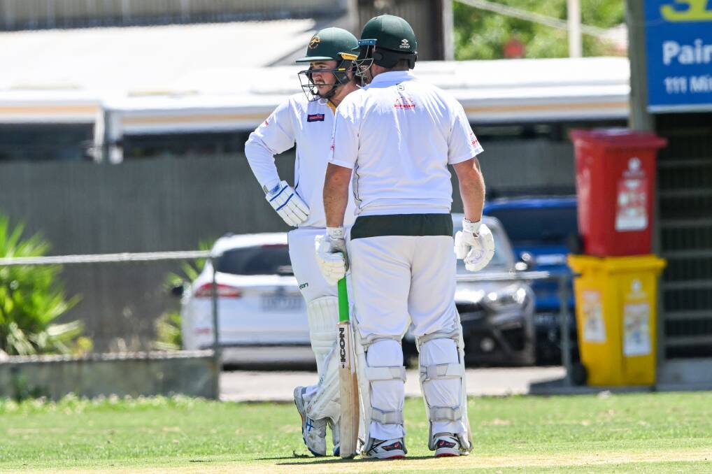 Adam Burns (back turned) batting with son, Riley, last Saturday. Picture by Darren Howe