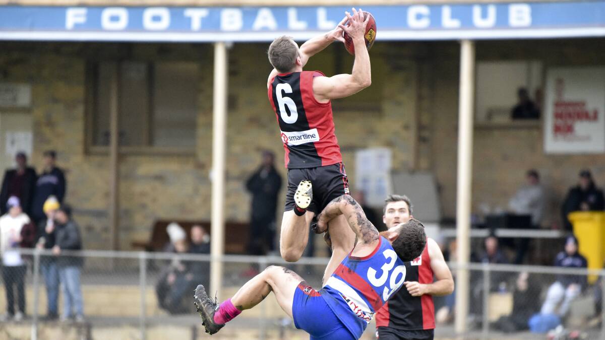 HIGH FLYER: White Hills' forward Mitch Dole soars for a mark in Saturday's 47-point defeat to North Bendigo at Atkins Street in the HDFNL. Picture: NONI HYETT