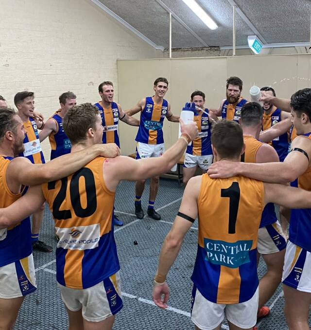VICTORIOUS: Golden Square players sing their team song after Saturday's round one win over South Bendigo at the QEO. Picture: LUKE WEST