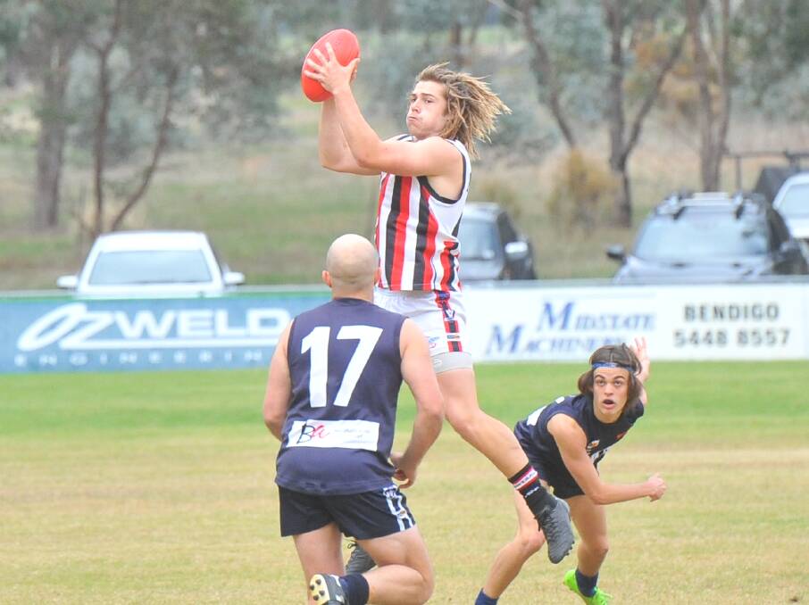 MARCHING SAINTS: Heathcote's Dylan McCutcheon takes possession of the ball on Saturday. The Saints beat Mount Pleasant by 26 points. Picture: LUKE WEST