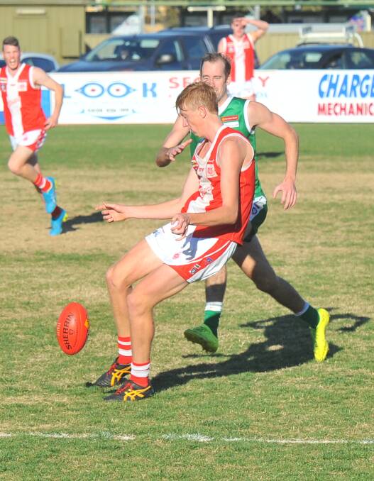 BACK ON THE WINNER'S LIST: South Bendigo co-captain Kieran Strachan gets a kick away during the Bloods' 77-point victory over Kangaroo Flat. Picture: LUKE WEST