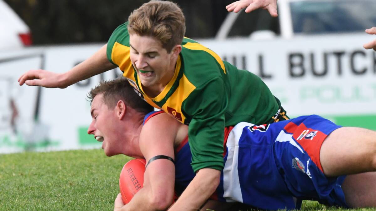 GOTCHA: Colbinabbin's Daniel Hill tackles North Bendigo's Jarrod Findlay on Saturday. The Bulldogs kicked 13 goals to six after quarter-time to win by 31 points and replace the Grasshoppers in the top three. Picture: DARREN HOWE