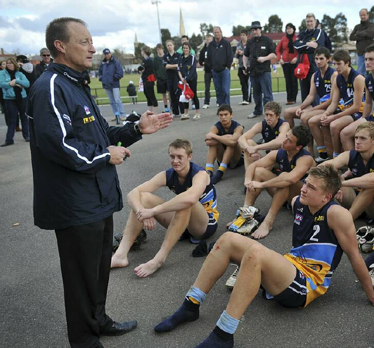 Ollie Wines (No.2) listens to Bendigo Pioneers' coach Mark Ellis after a game at the QEO in 2011.
