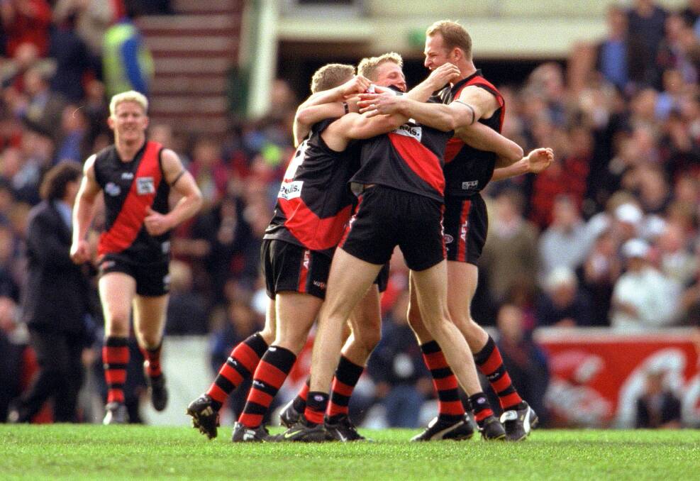 REDEMPTION: Essendon players celebrate at the final siren of the 2000 grand final. The Bombers beat Melbourne by 60 points to cap a 24-1 season. Picture: GETTY IMAGES