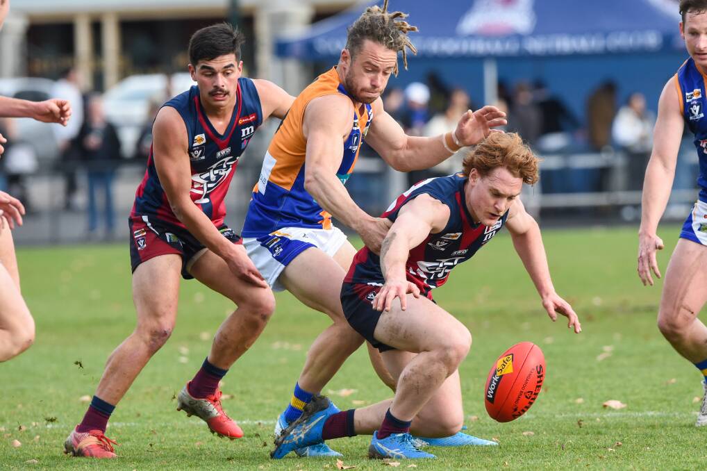 FIGHT FOR POSSESSION: Sandhurst's Lachie Hood prepares to pounce on the ball in front of Golden Square captain Jack Geary at the QEO on Saturday. More pictures online at www.bendigoadvertiser.com.au. Picture: DARREN HOWE
