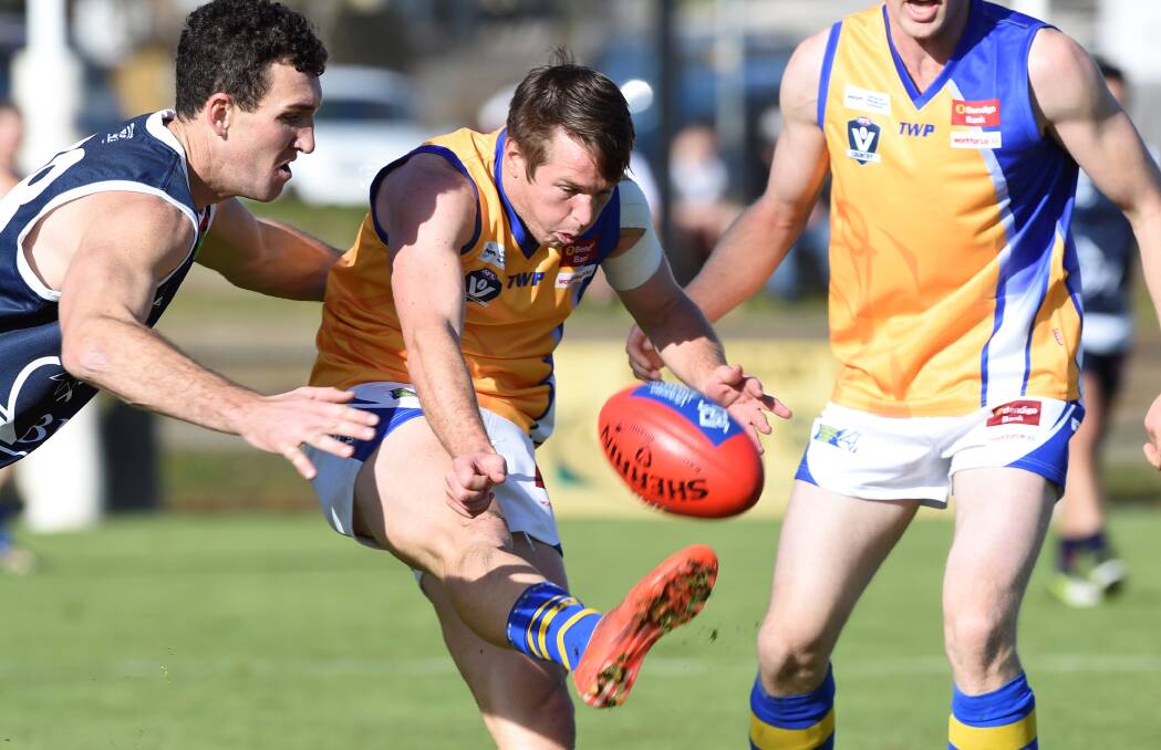 SKIPPER: Lee Coghlan gets a kick away in Bendigo's 77-point loss to Ballarat two years ago. Coghlan has been appointed captain of this year's team. Picture: BALLARAT COURIER