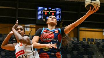 Alex Wilson scores two of her 17 points for the Bendigo Spirit against Sydney at Red Energy Arena on Saturday night. Picture by Darren Howe