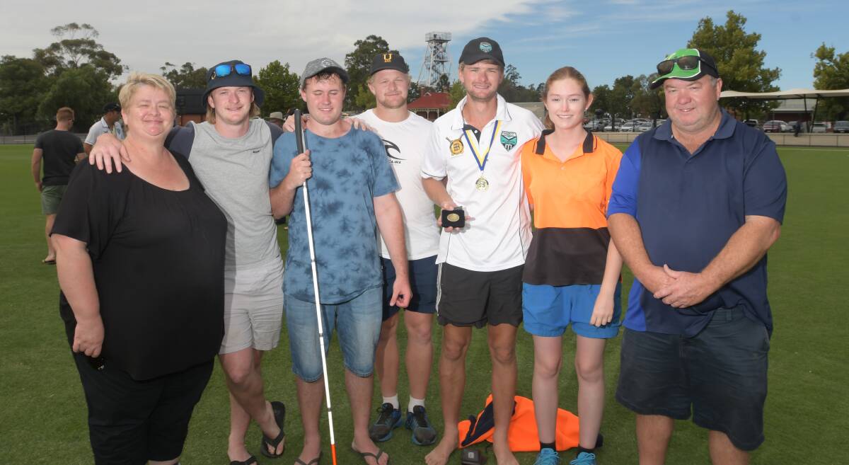 PROUD: Mitch Whittle with his family following his match-winning BDCA grand final performance for Huntly-North Epsom at the QEO. Pictures: NONI HYETT