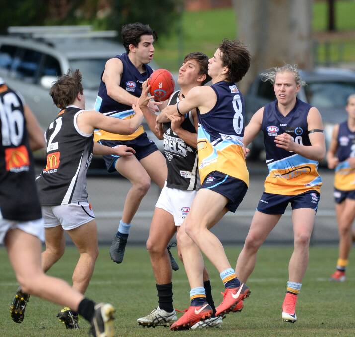 WRAPPED UP: Bendigo Pioneer Brodie Kemp lays a strong tackle during Sunday's TAC Cup match at the QEO against Greater Western Victoria. Pictures: GLENN DANIELS