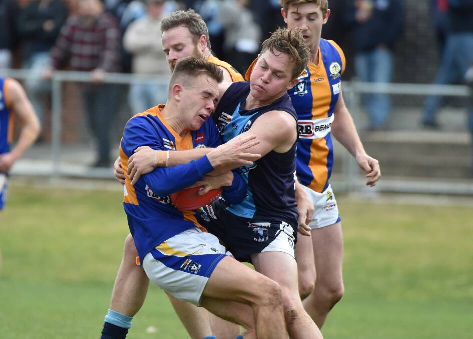 HOT CONTEST: Eaglehawk's Riley Saunders lays a tackle on Golden Square's Jake Thrum on Saturday. The Hawks avenged their loss to the Bulldogs from earlier in the season, winning by 16 points at Canterbury Park. Pictures: GLENN DANIELS